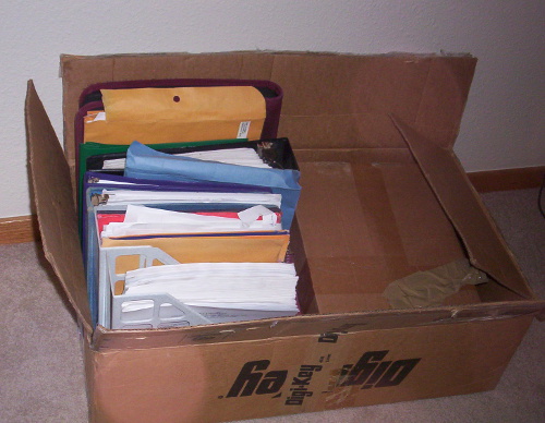 There is a stack of notebooks and manuscripts under that manuscript-sized box on the right half, too.
