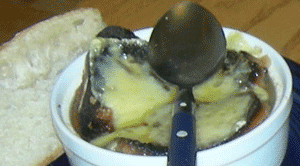 French onion soup, and the spoon with which I hope to conquer it. French onion soup, and the spoon with which I hope to conquer it.